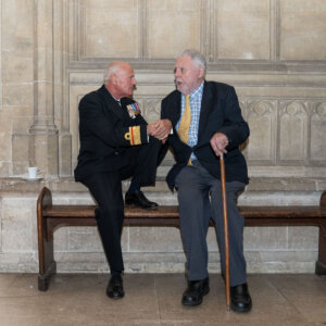 A man in ceremonial uniform talking to Sir Terry Waite at Winchester Cathedral