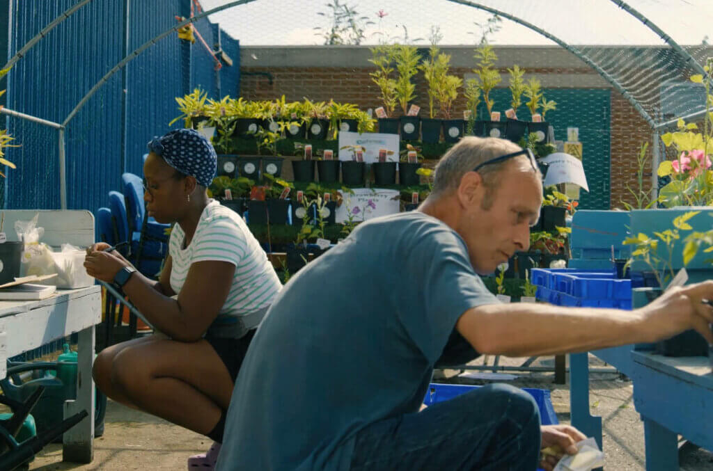 A still from the film, which is in the finals of the Smiley Charity Film Awards. A man and a woman working in the community garden at Emmaus Merseyside